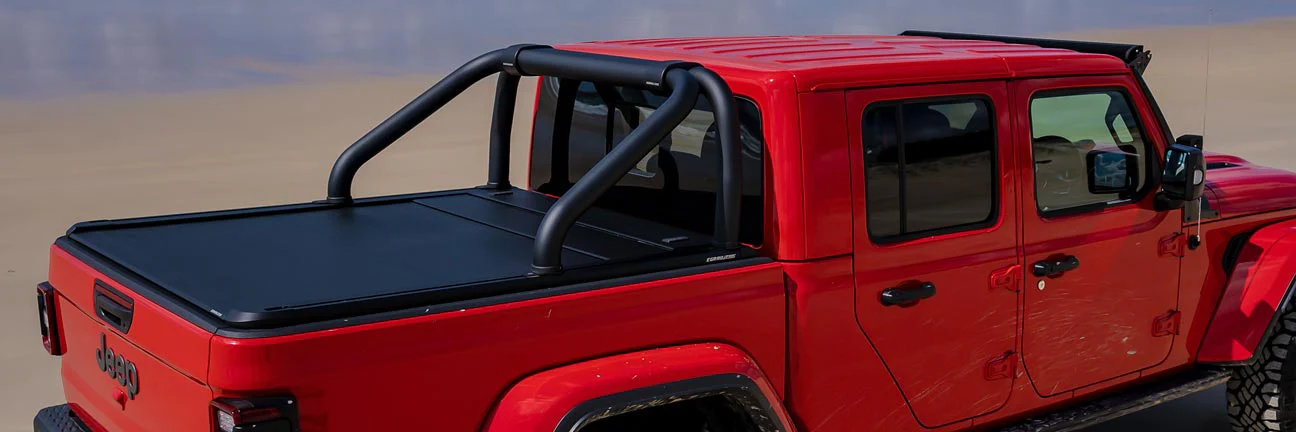 EGR sports bars installed on the tray of a red jeep with EGR electric hard tonneau cover