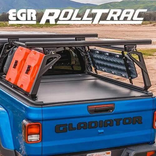 Blue Jeep Gladiator fitted with an EGR RollTrac bed cover and overland rack carrying water cans and traction boards